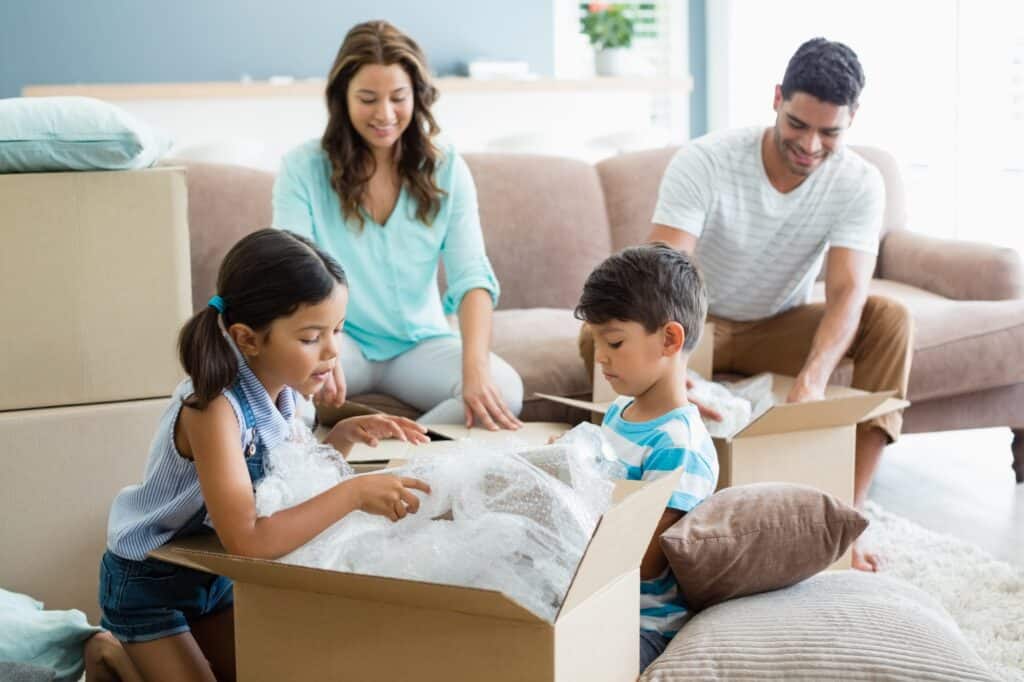 A young family unpacking boxes in their new house